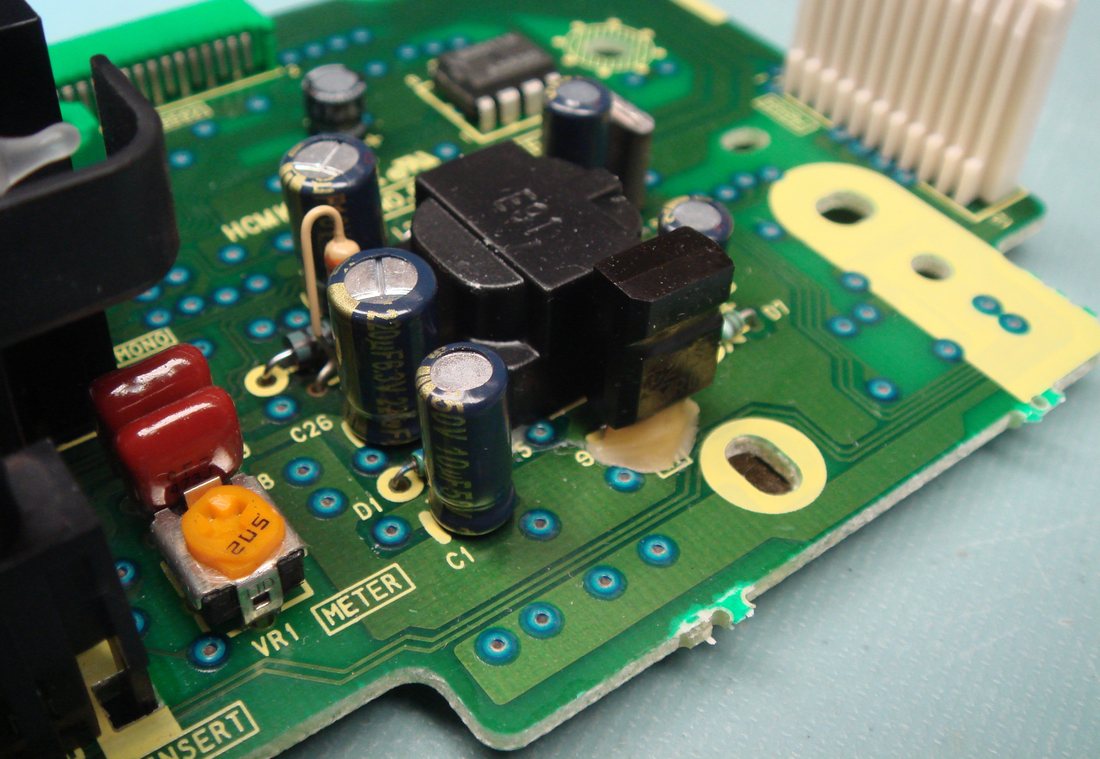 An AG-1980 display board after a full recap, with new blue long-life capacitors sitting flat and clean pads with no flux residue