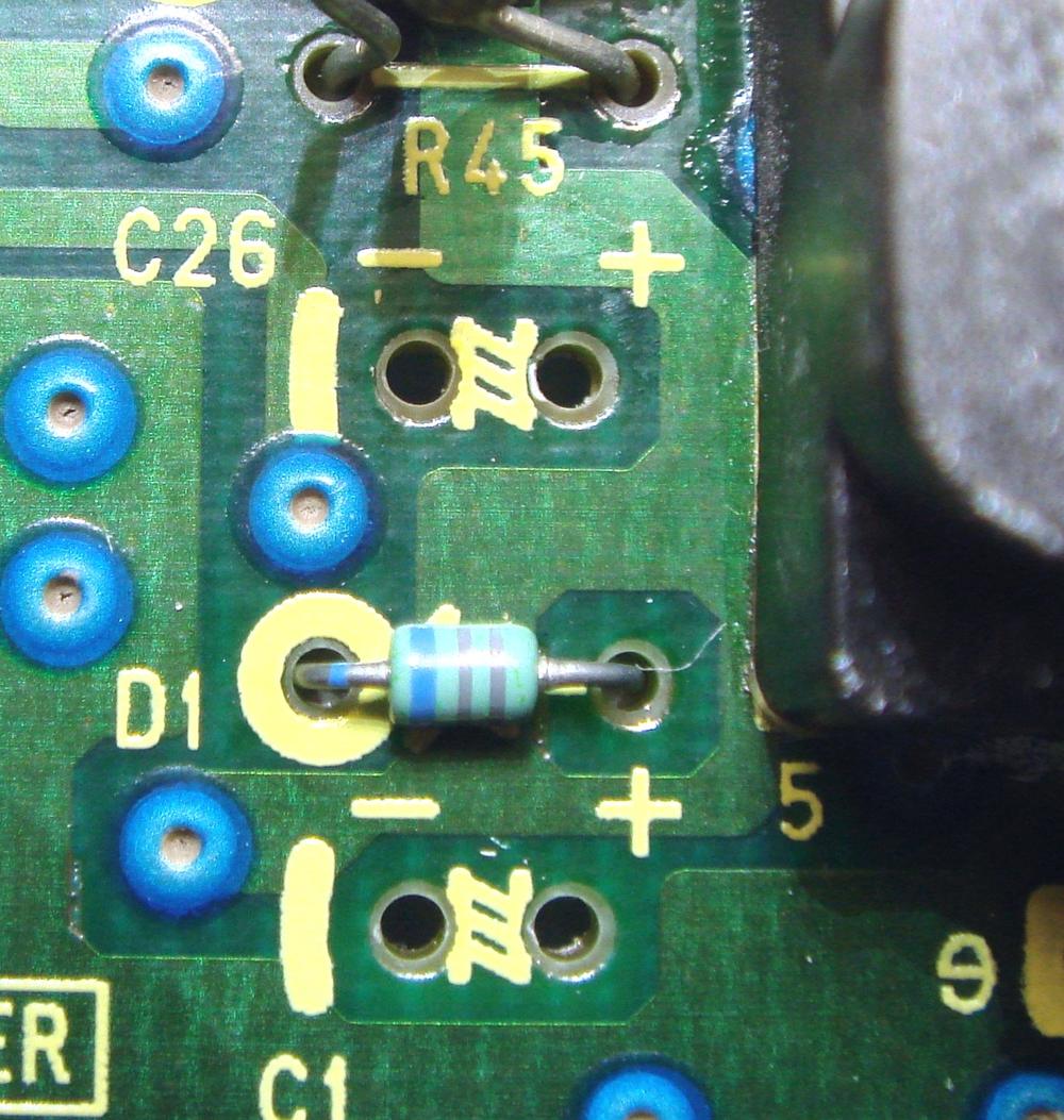The same two pads after cleaning, with bare board and silkscreen visible